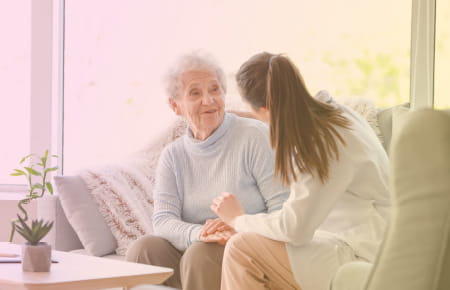 elderly woman talking to female doctor